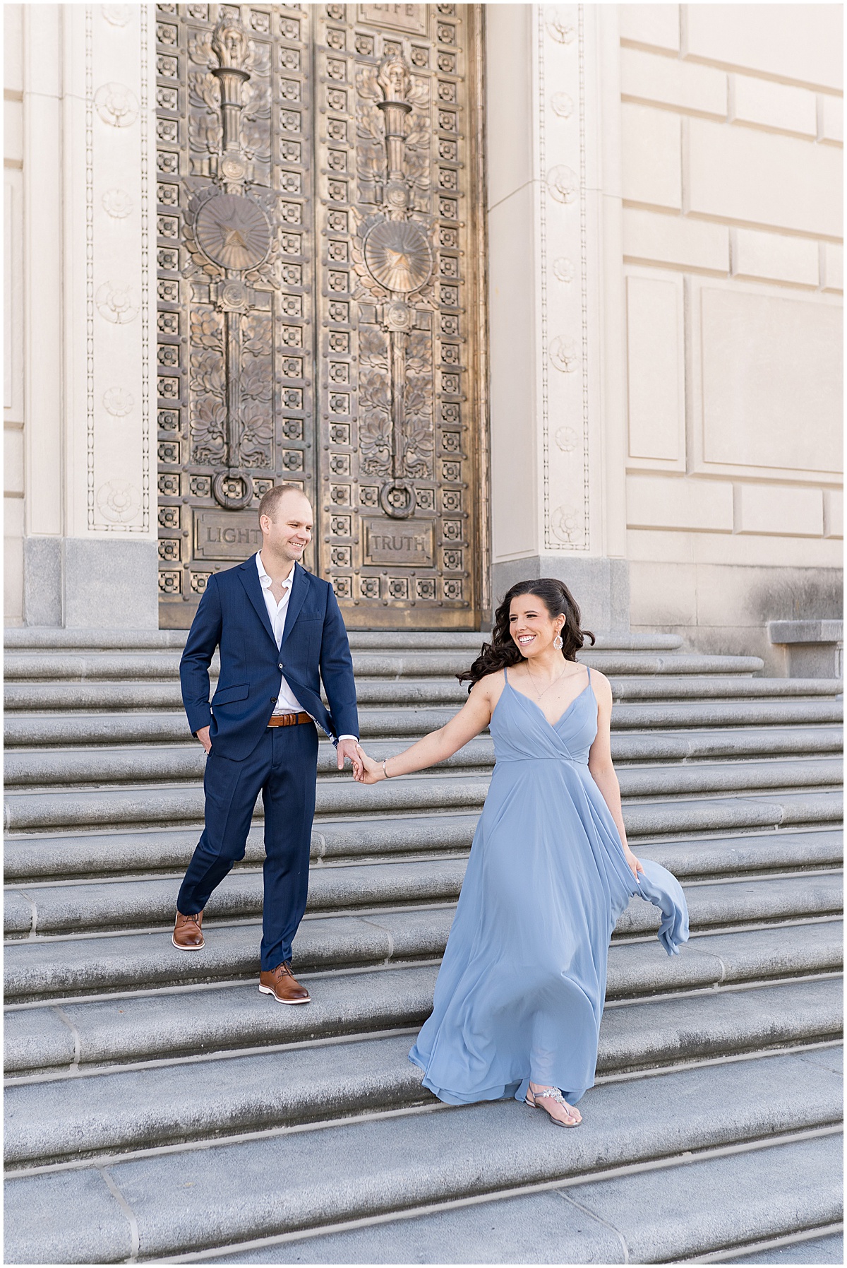 Couple walk down steps at Indiana War Memorial during Downtown Engagement Photos