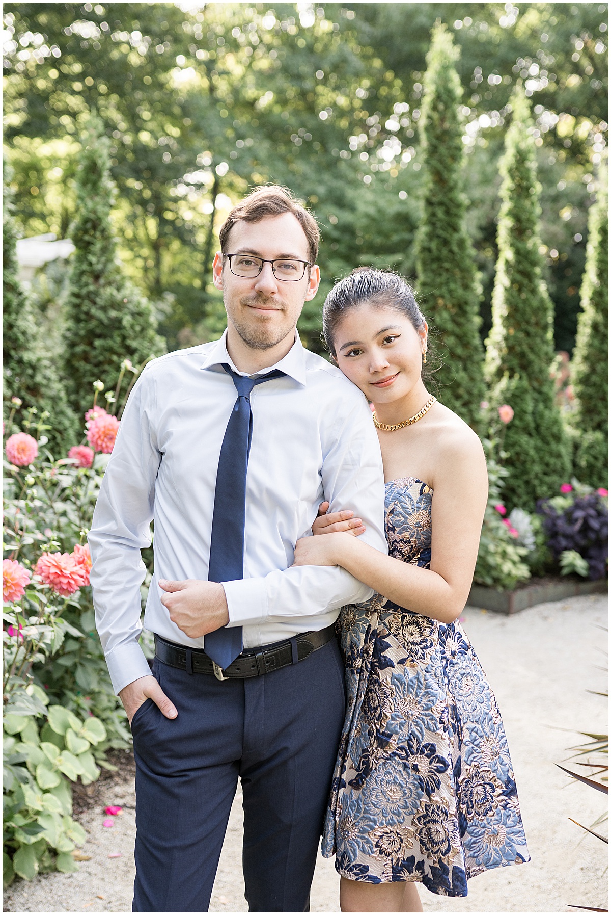 Couple get close on stone path during garden engagement photos at Newfields in Indianapolis