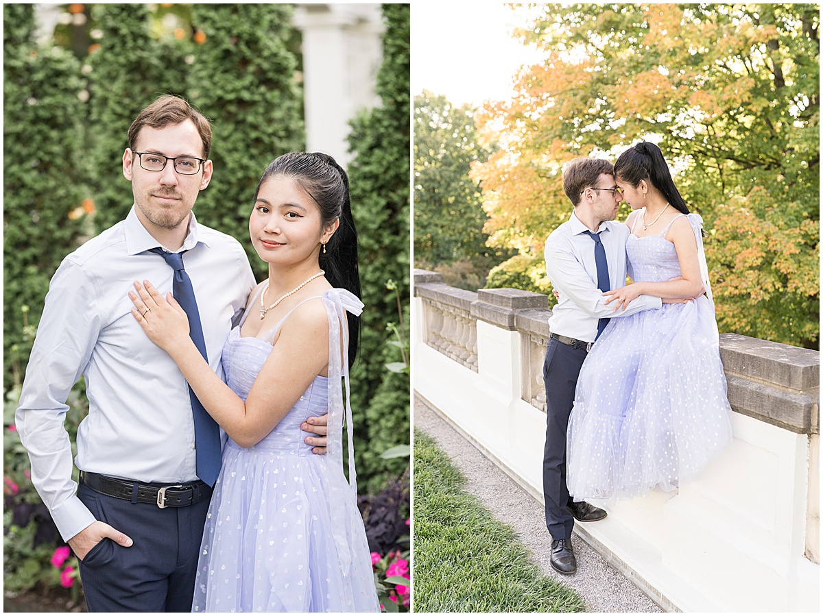 Couple sits on stone ledge during garden engagement photos at Newfields in Indianapolis