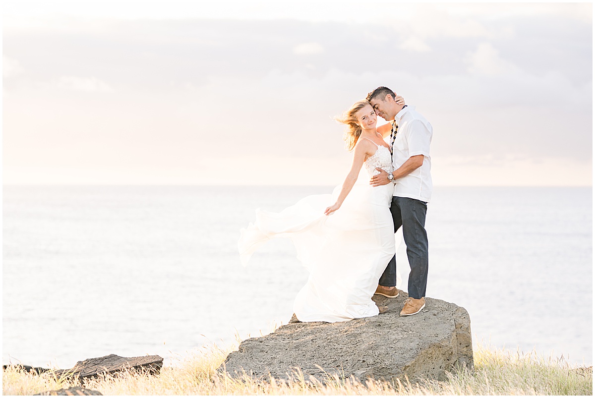 Couple embrace by the ocean at South Point Hawaii elopement photographed by Victoria Rayburn Photography