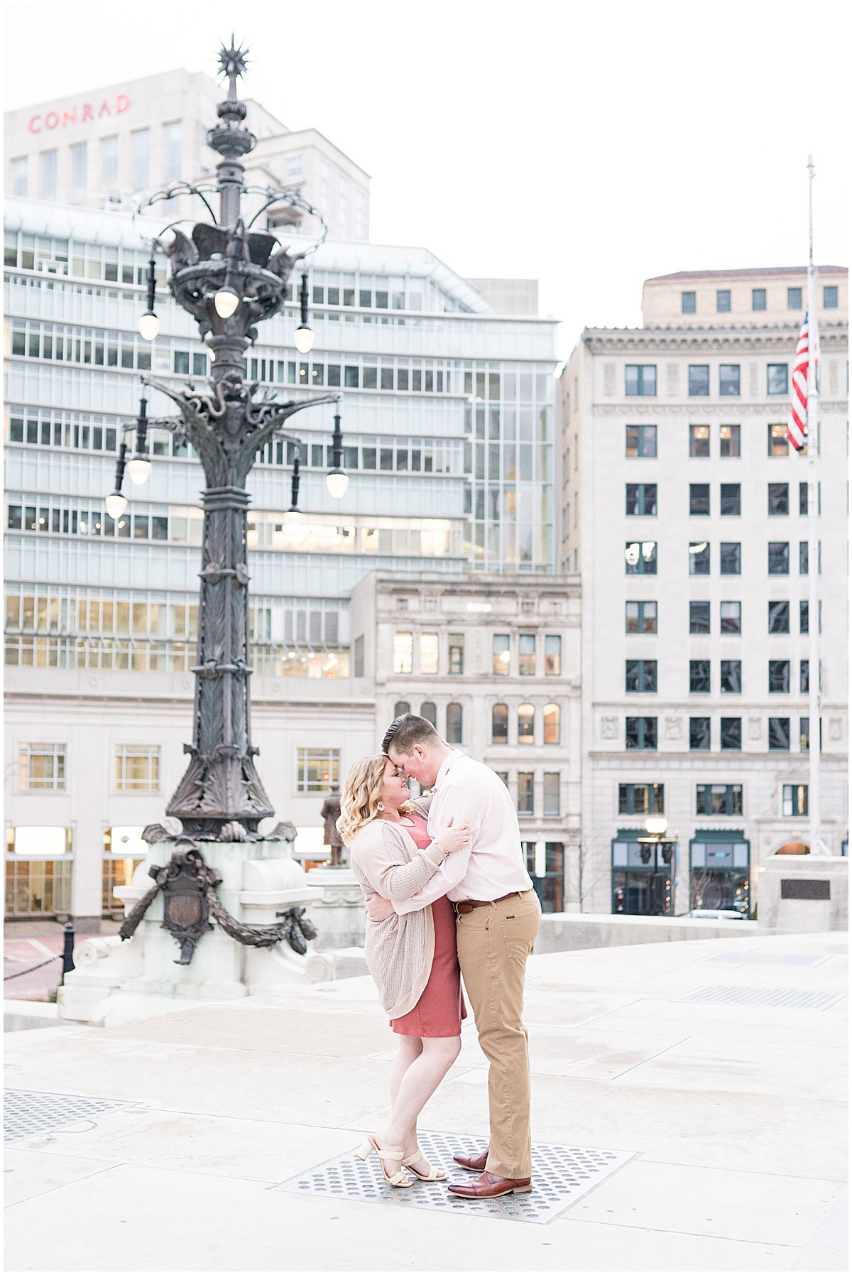 Couple embace in Monument Circle featured in the “Victoria Rayburn Photography Best of Engagement Photos 2022” blog post.