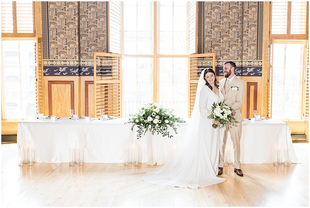 Bride and groom laugh in front of head table at Delphi Opera House wedding photographed by Victoria Rayburn Photography