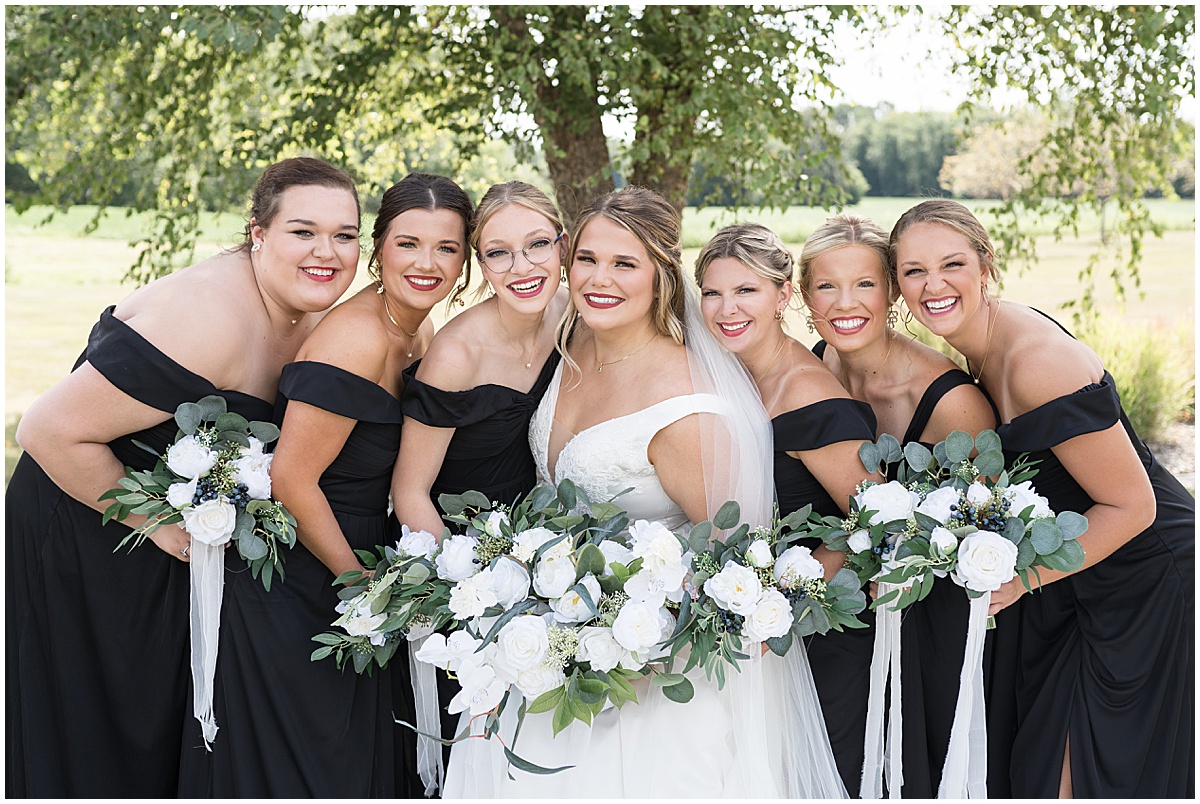 Bride with bridesmaids in black dresses at wedding in Converse, Indiana photographed by Victoria Rayburn Photography