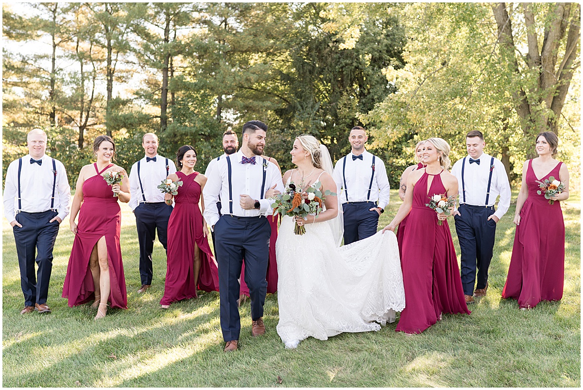 Bridal party walk in field at fall wedding at The Ritz Charles Garden Pavilion in Carmel, Indiana photographed by Victoria Rayburn Photography