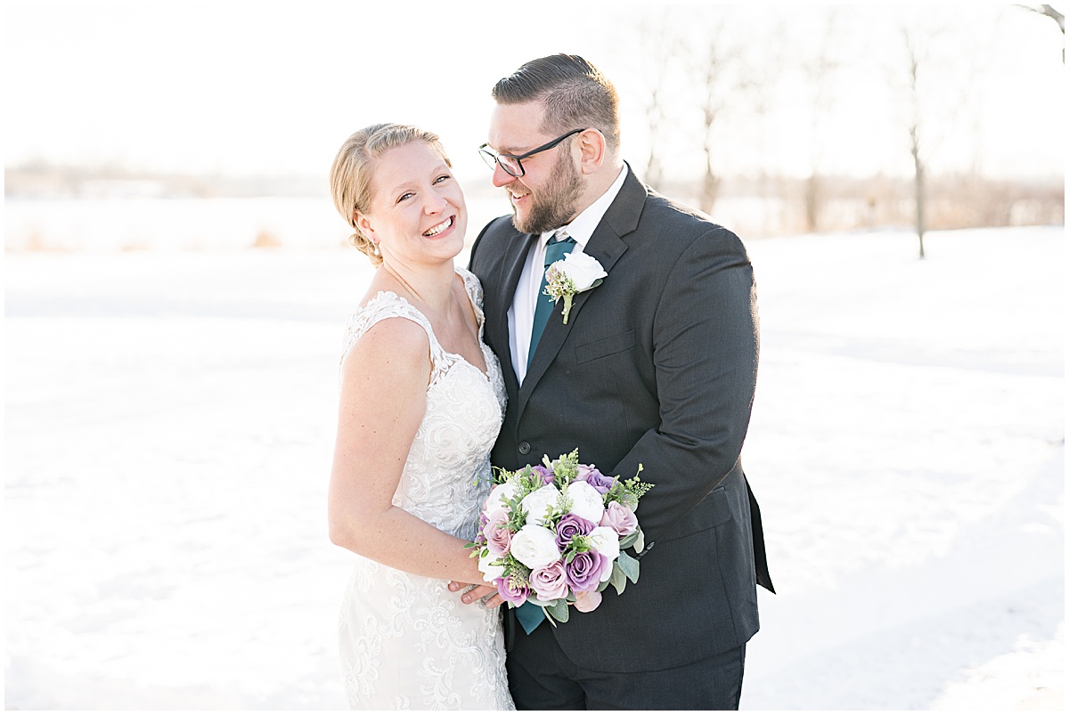 Couple laughing on snowy path during wedding photos at Centennial Park in Orland Park, Illinois photographed by Victoria Rayburn Photography