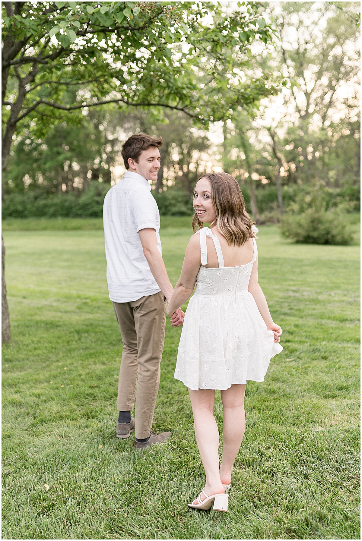 Couple in white during engagement photos at Holcomb Gardens in Indianapolis.