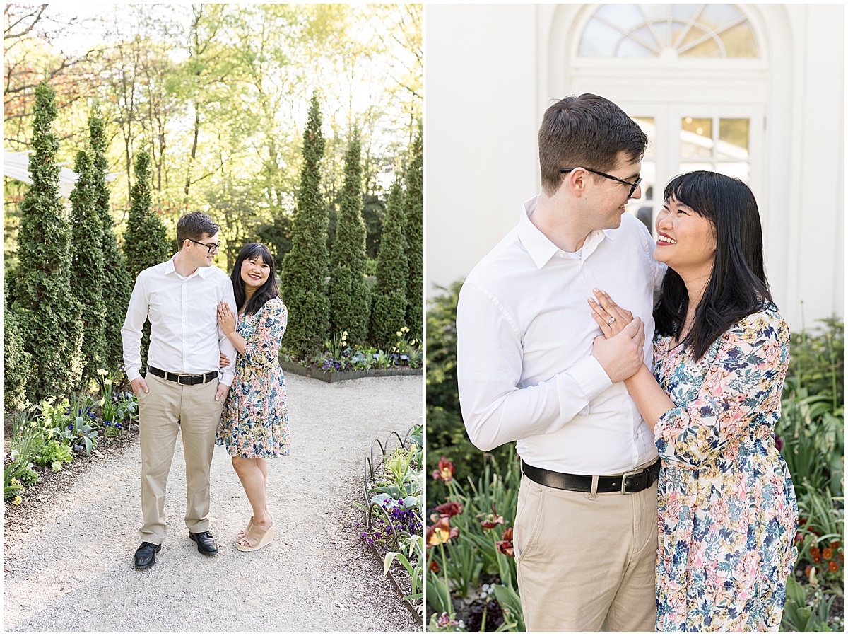 Couple laugh in garden at engagement photos at Newfields in Indianapolis.