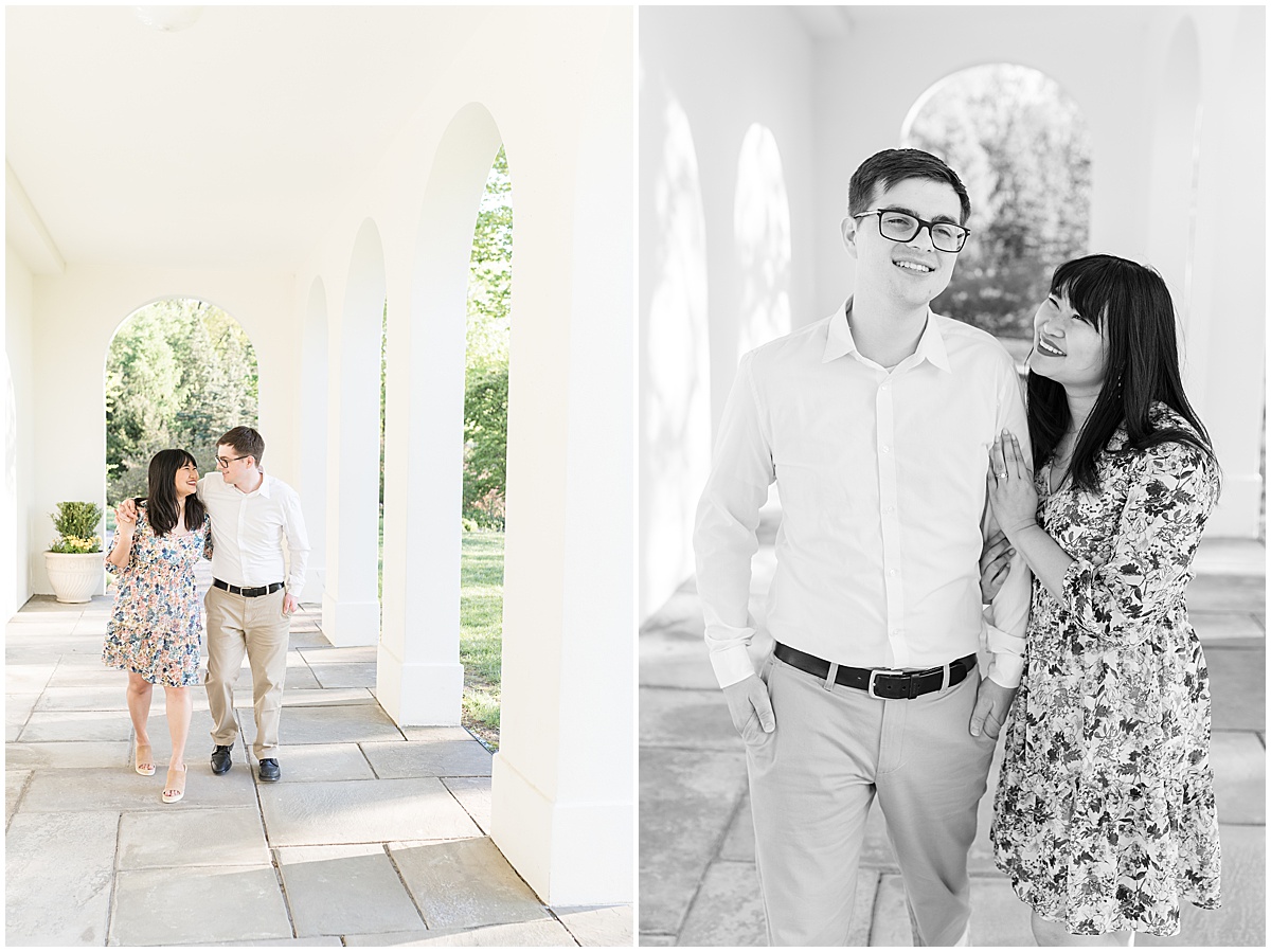 Couple walk under archway during engagement photos at Newfields in Indianapolis.