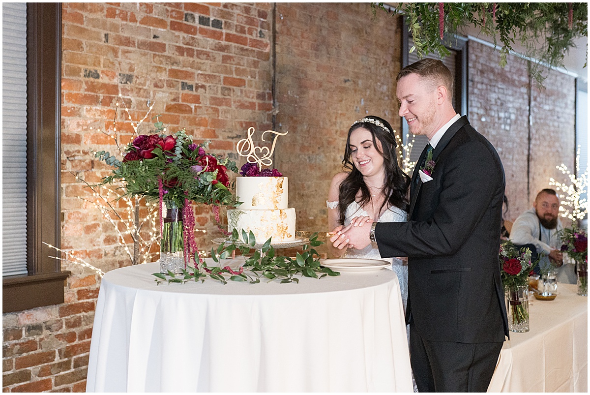 Bride and groom cutting cake during Historic Saint Joseph Hall wedding in Indianapolis