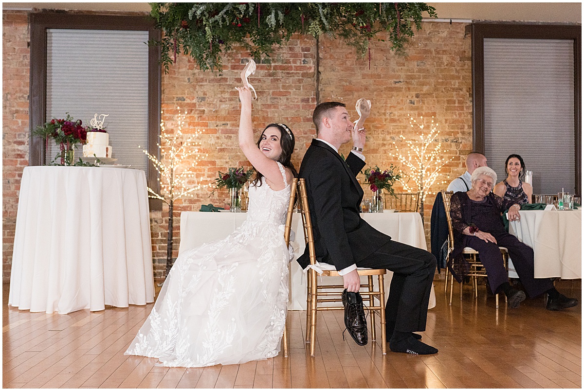 Bride and game playing shoe game during during Historic Saint Joseph Hall wedding in Indianapolis