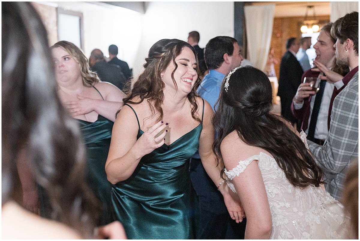 Bride and maid of honor dancing during Historic Saint Joseph Hall wedding in Indianapolis