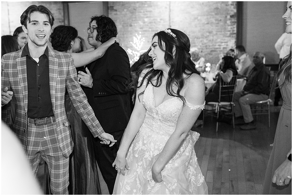 Bride dancing with guests on dance floor during Historic Saint Joseph Hall wedding in Indianapolis