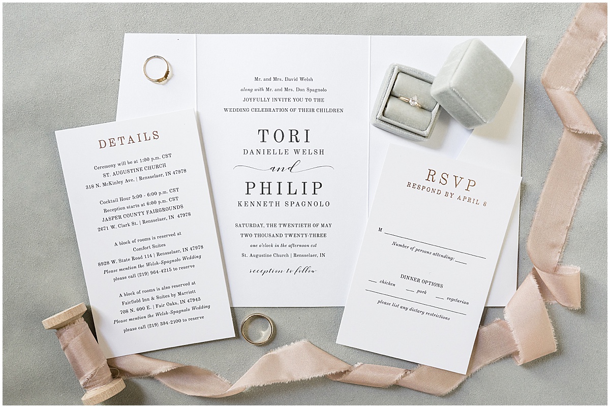 White and black invitations for wedding at St. Augustine Catholic Church in Rensselaer, Indiana