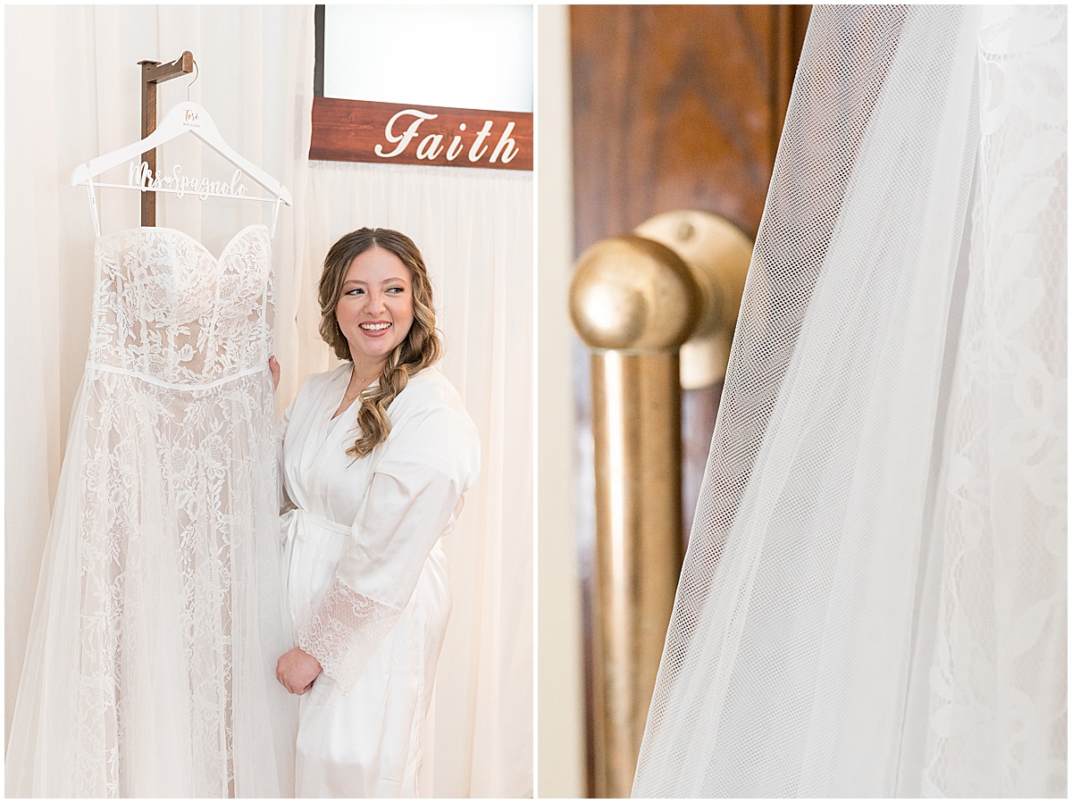 Bride admiring hanging dress before wedding at St. Augustine Catholic Church in Rensselaer, Indiana