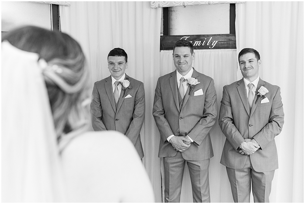 Groomsmen reaction to bride at wedding at St. Augustine Catholic Church in Rensselaer, Indiana
