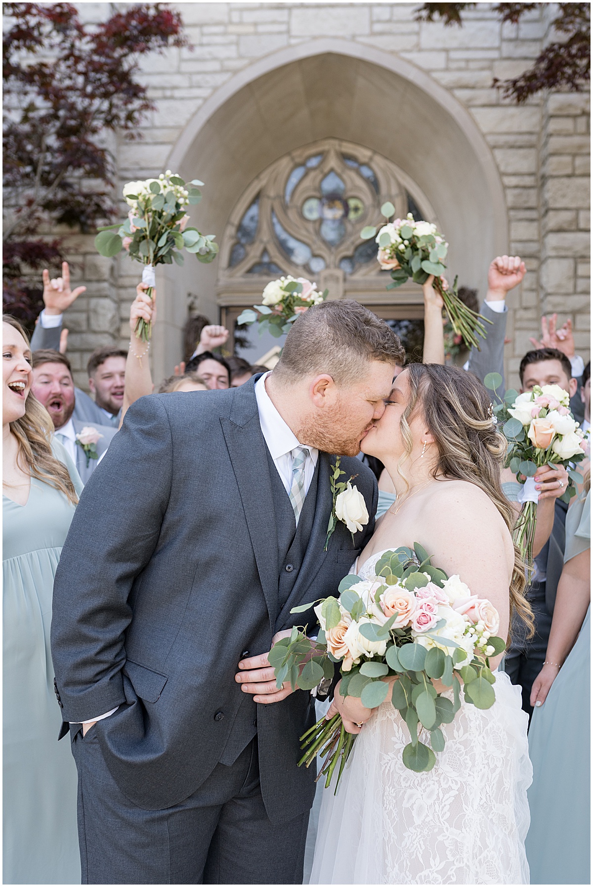 Newlyweds kiss after wedding at St. Augustine Catholic Church in Rensselaer, Indiana