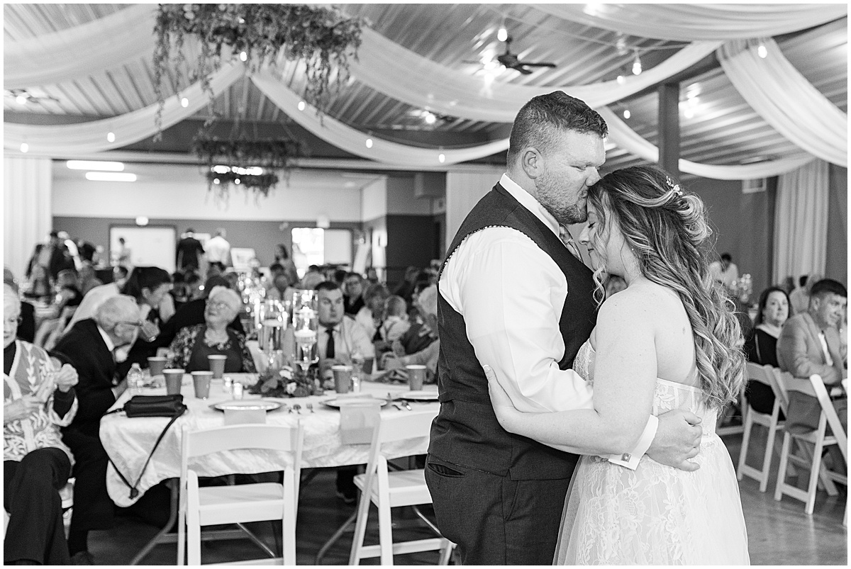 Groom kisses bride during dance at Jasper County Fairgrounds wedding