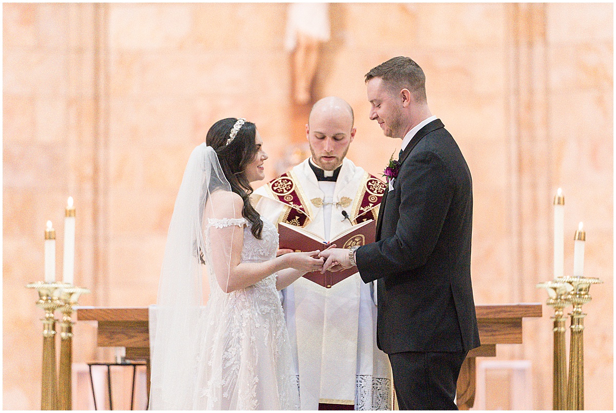 Couple exchanging rings during Saint Mary's Catholic Cathedral wedding in downtown Indianapolis