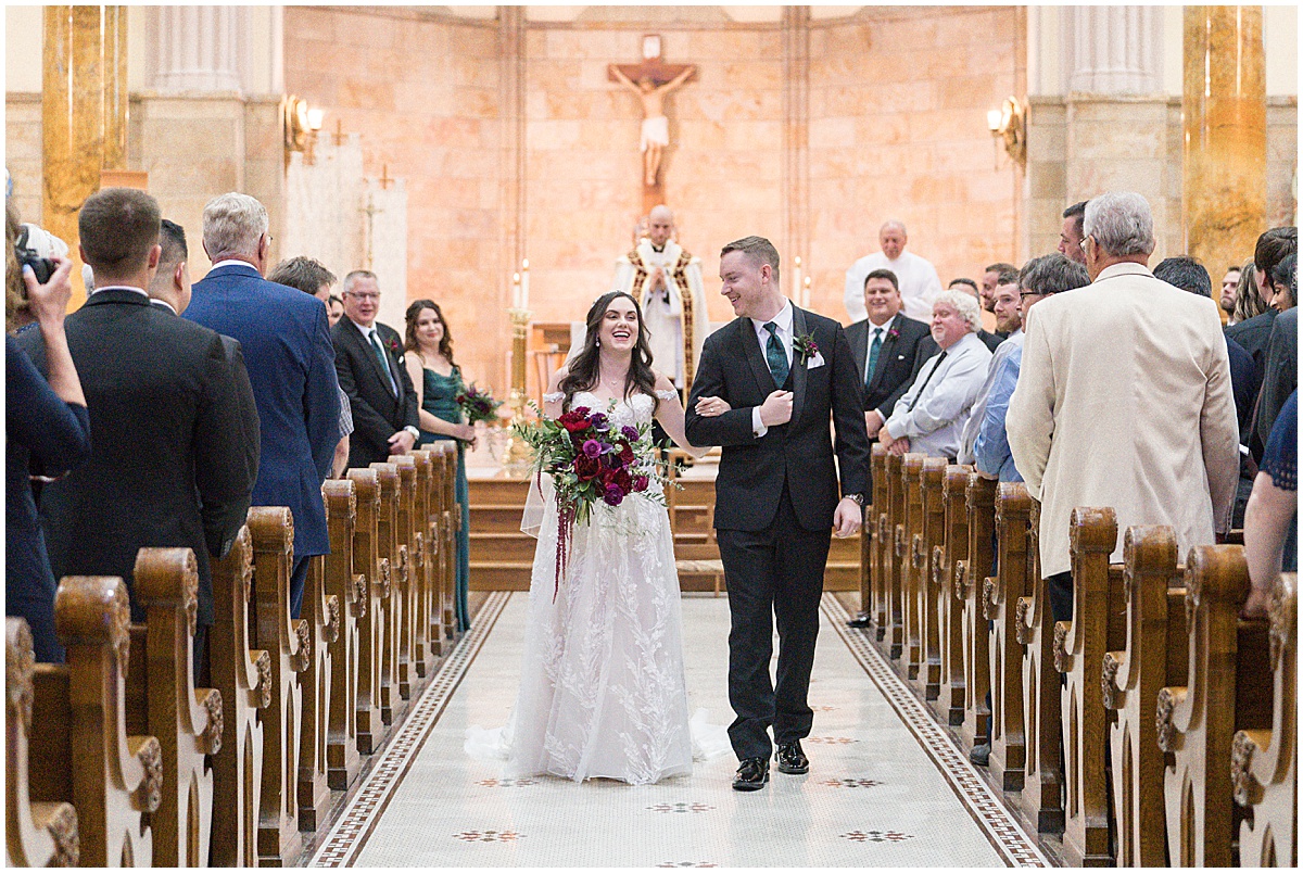 Couple walking up aisle after getting married during Saint Mary's Catholic Cathedral wedding in downtown Indianapolis