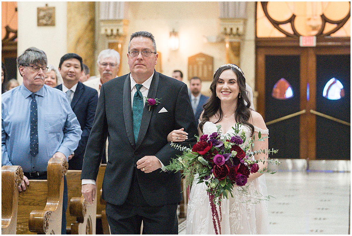 Bride walking down aisle with father during Saint Mary's Catholic Cathedral wedding in downtown Indianapolis