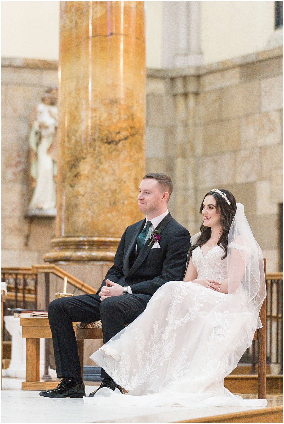 Bride and groom sitting at altar during Saint Mary's Catholic Cathedral wedding in downtown Indianapolis