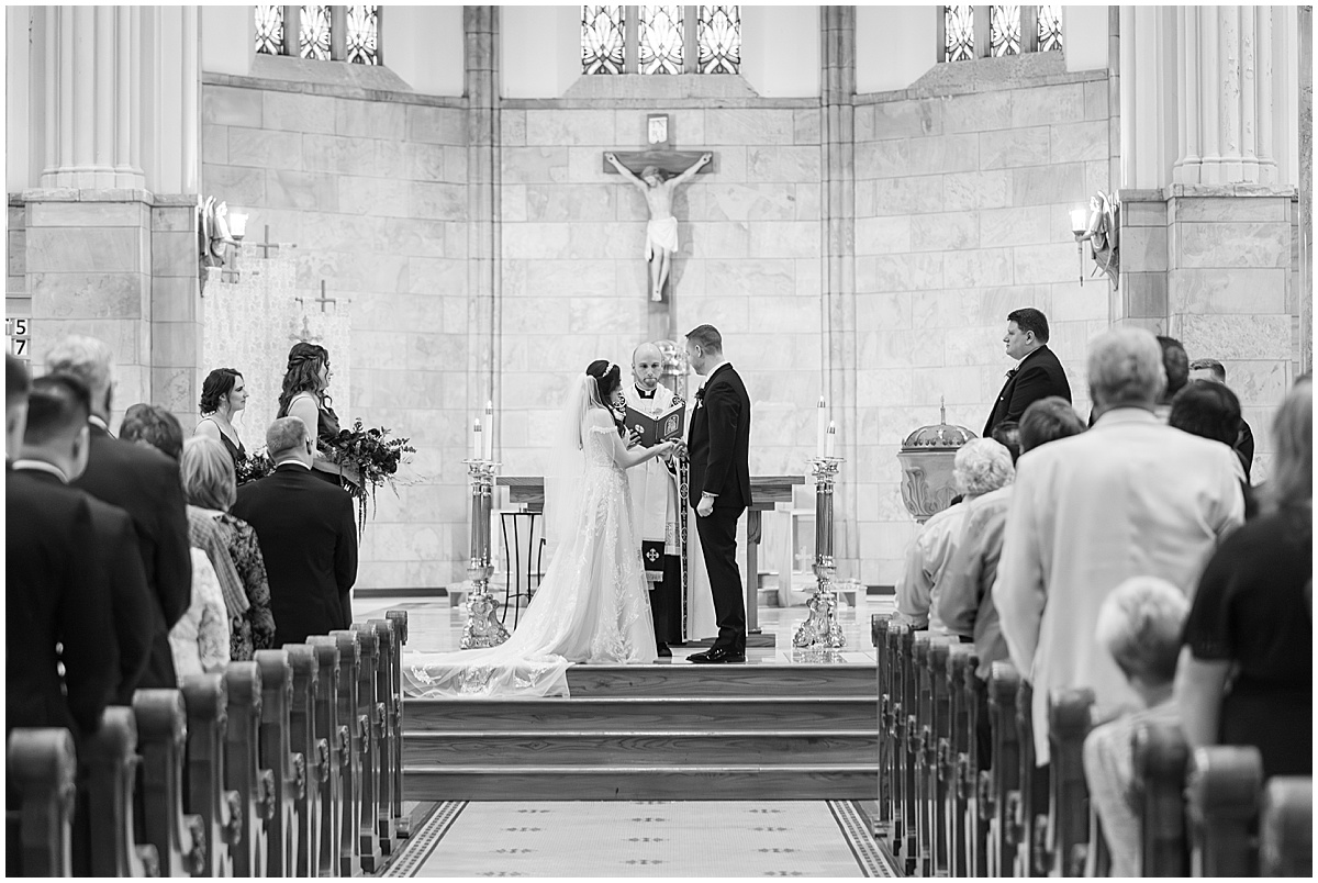 Couple holding hands at altar during Saint Mary's Catholic Cathedral wedding in downtown Indianapolis