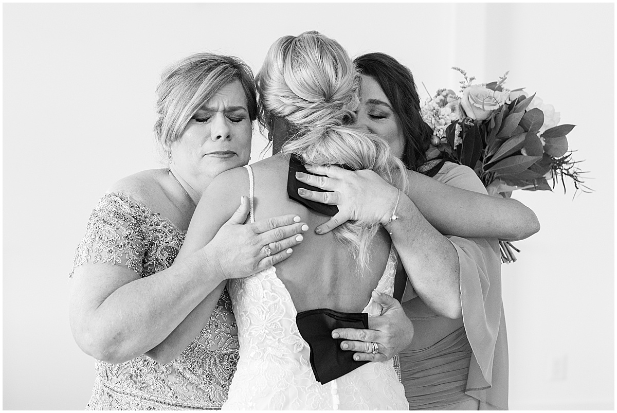 Bride hugs family before wedding at New Journey Farms in Lafayette, Indiana