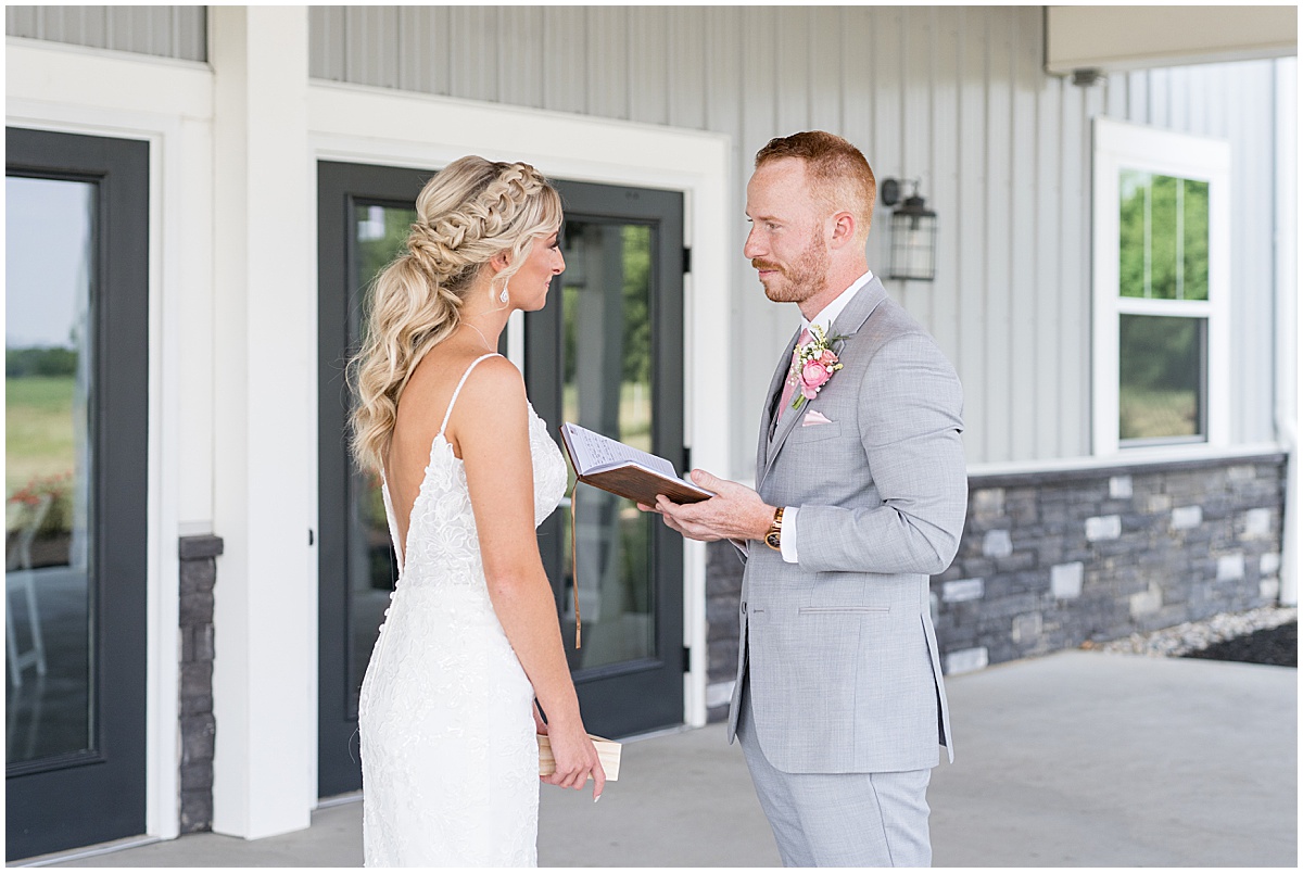 Bride and groom read personal vows before wedding at New Journey Farms in Lafayette, Indiana