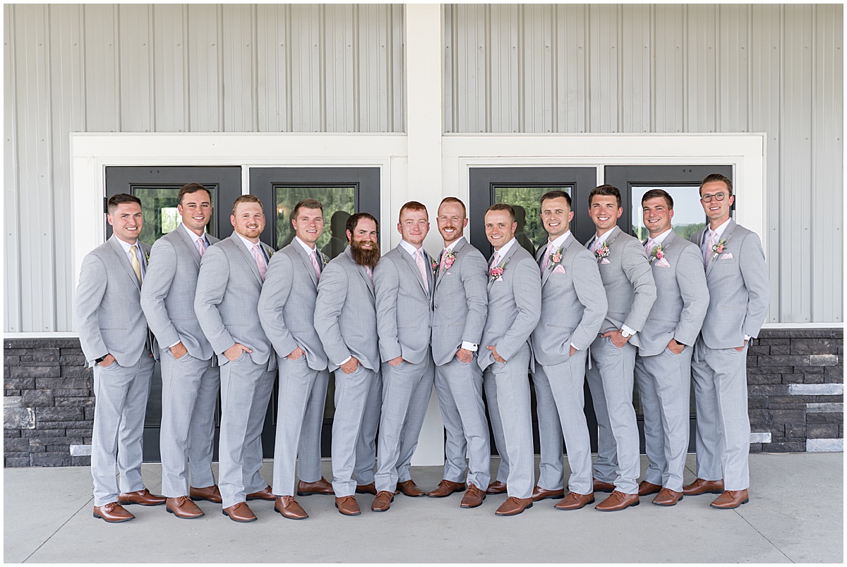 Groomsmen stand together outside before wedding at New Journey Farms in Lafayette, Indiana