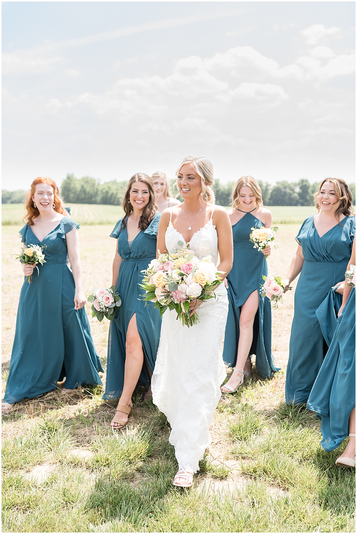 Bride walks with bridesmaids before wedding at New Journey Farms in Lafayette, Indiana
