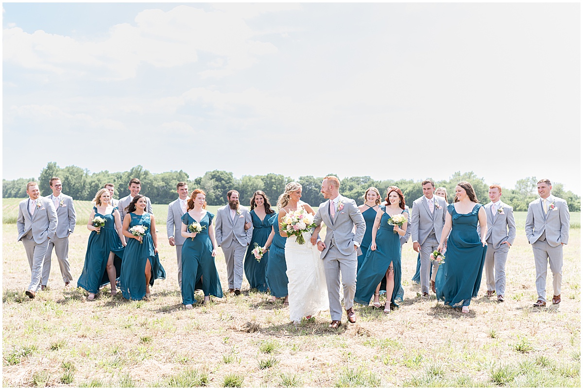Bridal party walks together before wedding at New Journey Farms in Lafayette, Indiana