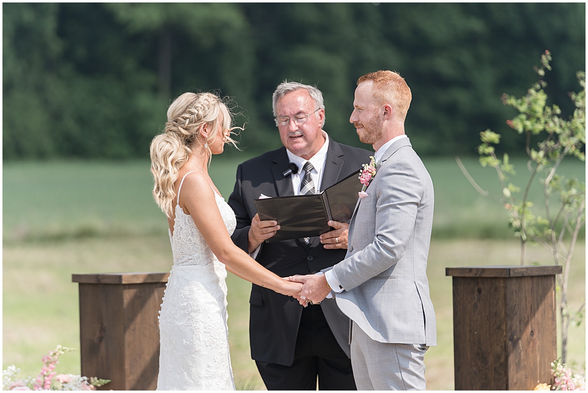 Couple exchanges vows during wedding at New Journey Farms in Lafayette, Indiana