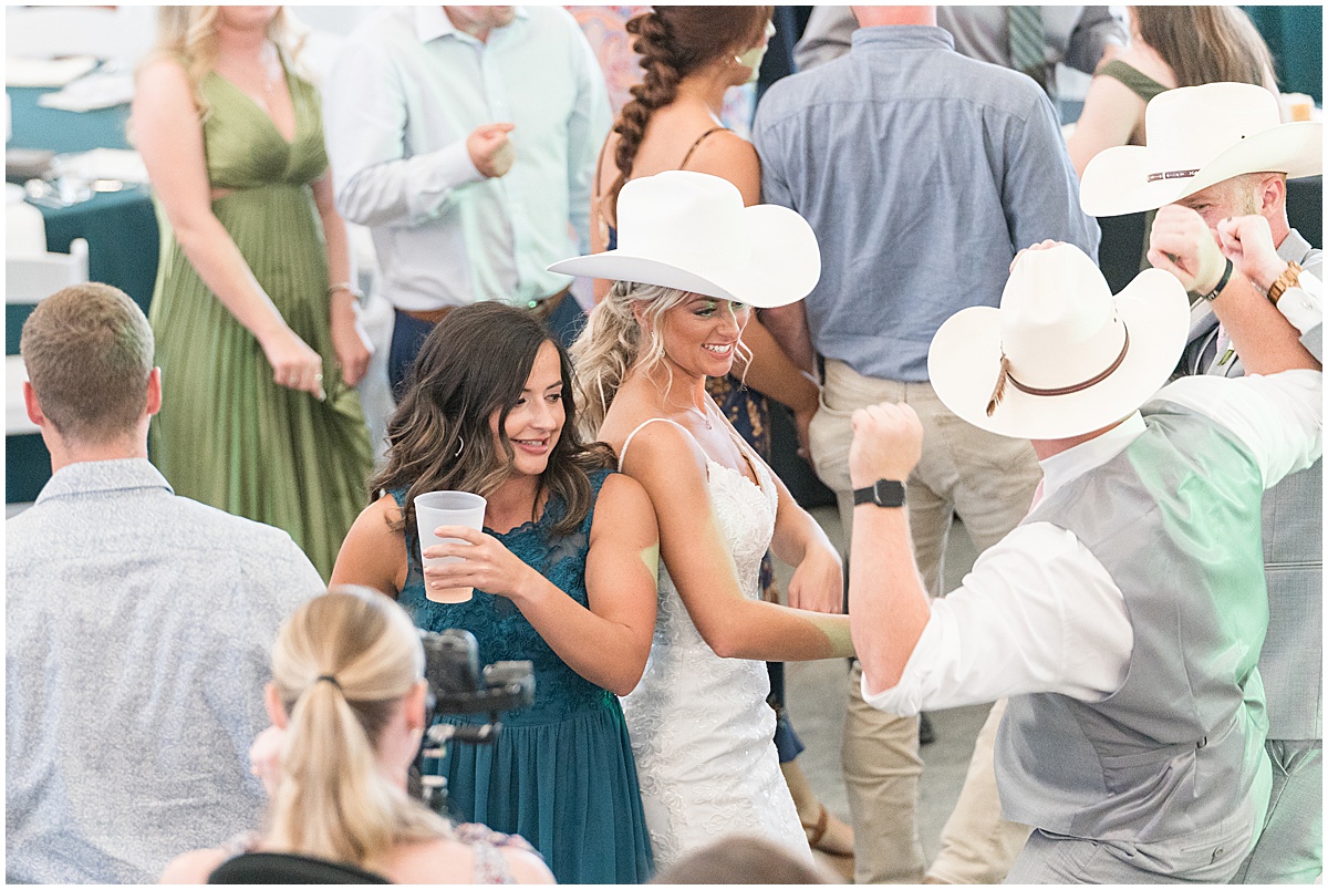 Bride dancing in cowboy hat at New Journey Farms in Lafayette, Indiana