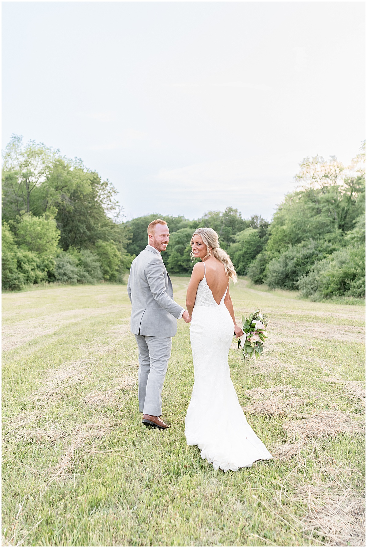 Bride and groom hold hands after wedding at New Journey Farms in Lafayette, Indiana