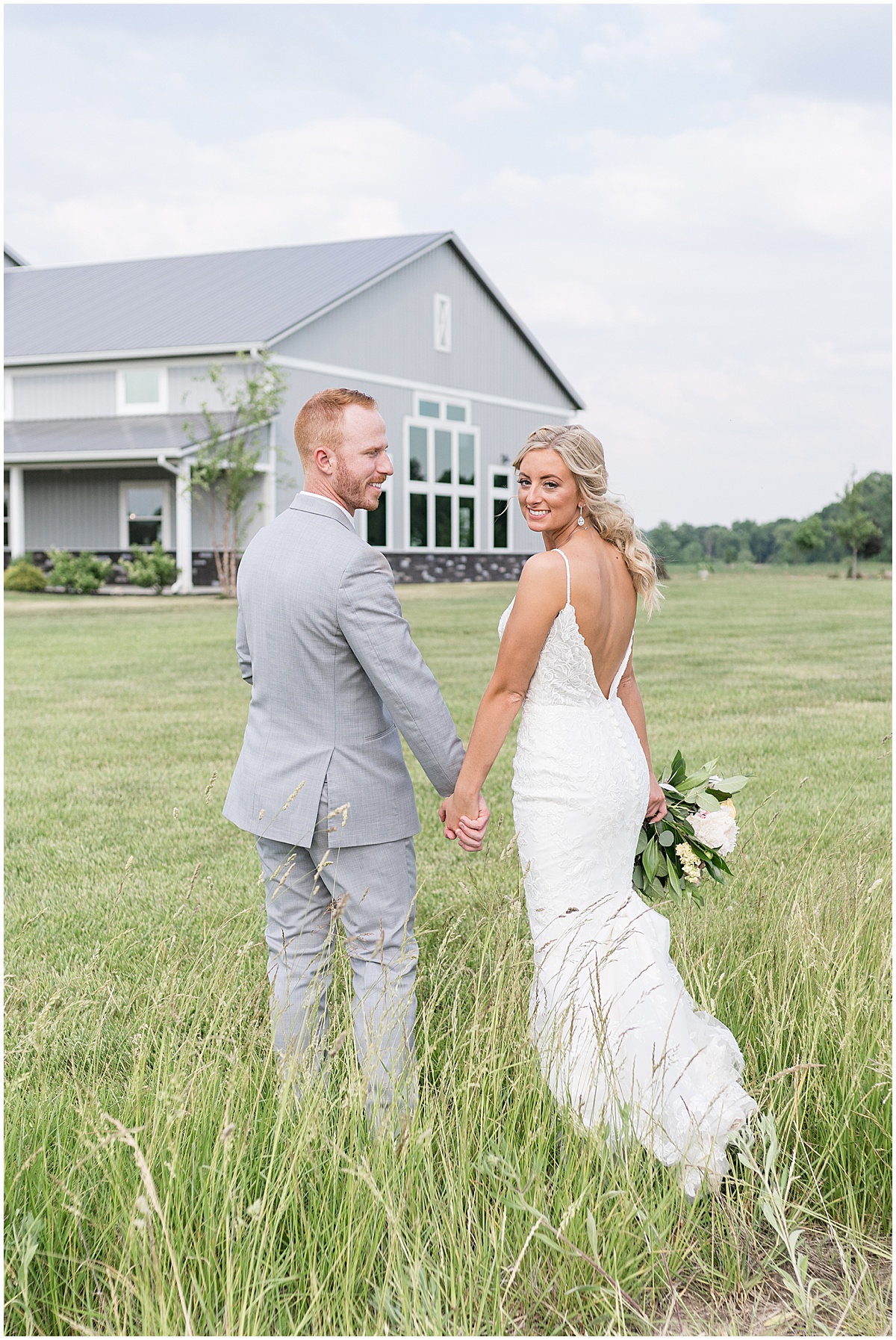 Groom leads bride through field after wedding at New Journey Farms in Lafayette, Indiana