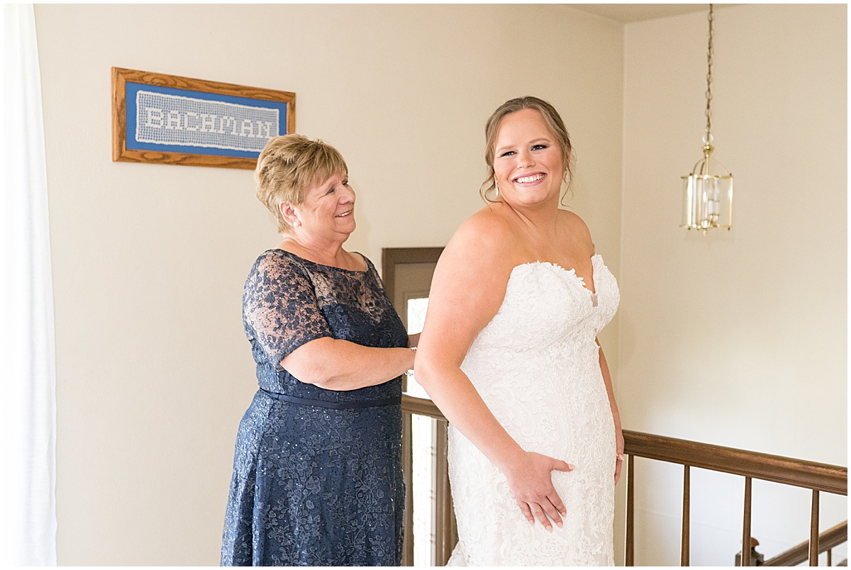 Mother helps bride get ready before St. Joseph Catholic Church in Jasper, Indiana