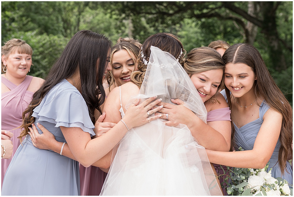 Bridesmaids hug bride before Stables Event Center wedding in Lafayette, Indiana