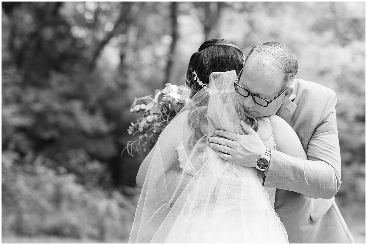 Father of the bride hugs bride before Stables Event Center wedding in Lafayette, Indiana