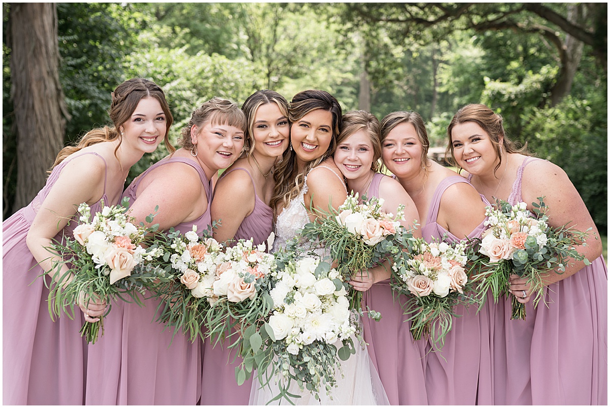 Bride huddles with bridesmaids at Stables Event Center wedding in Lafayette, Indiana