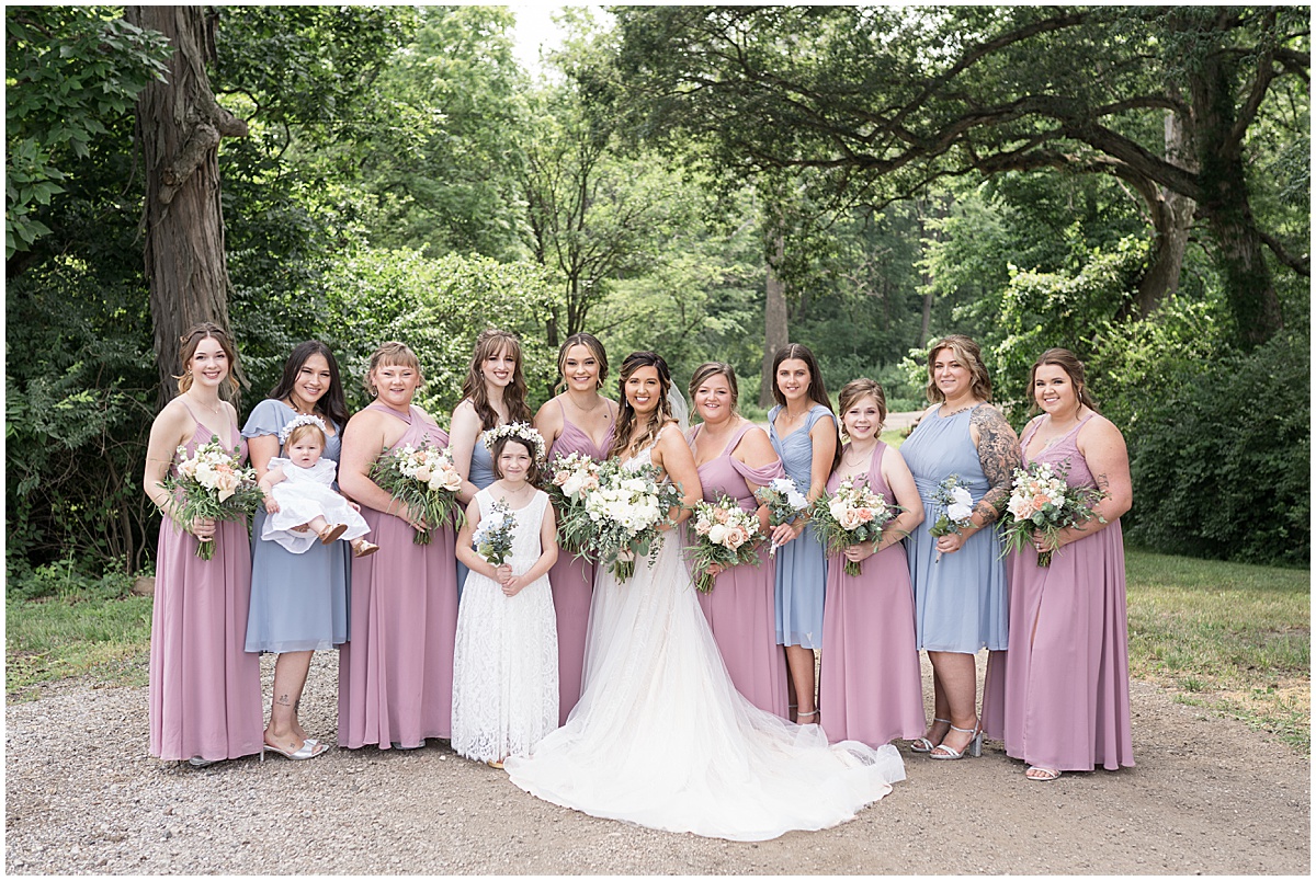 Bride with all bridesmaids at Stables Event Center wedding in Lafayette, Indiana