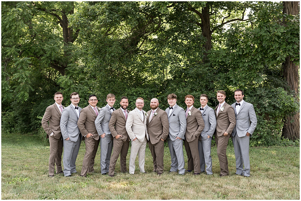 Groomsmen stand with ushers at Stables Event Center wedding in Lafayette, Indiana