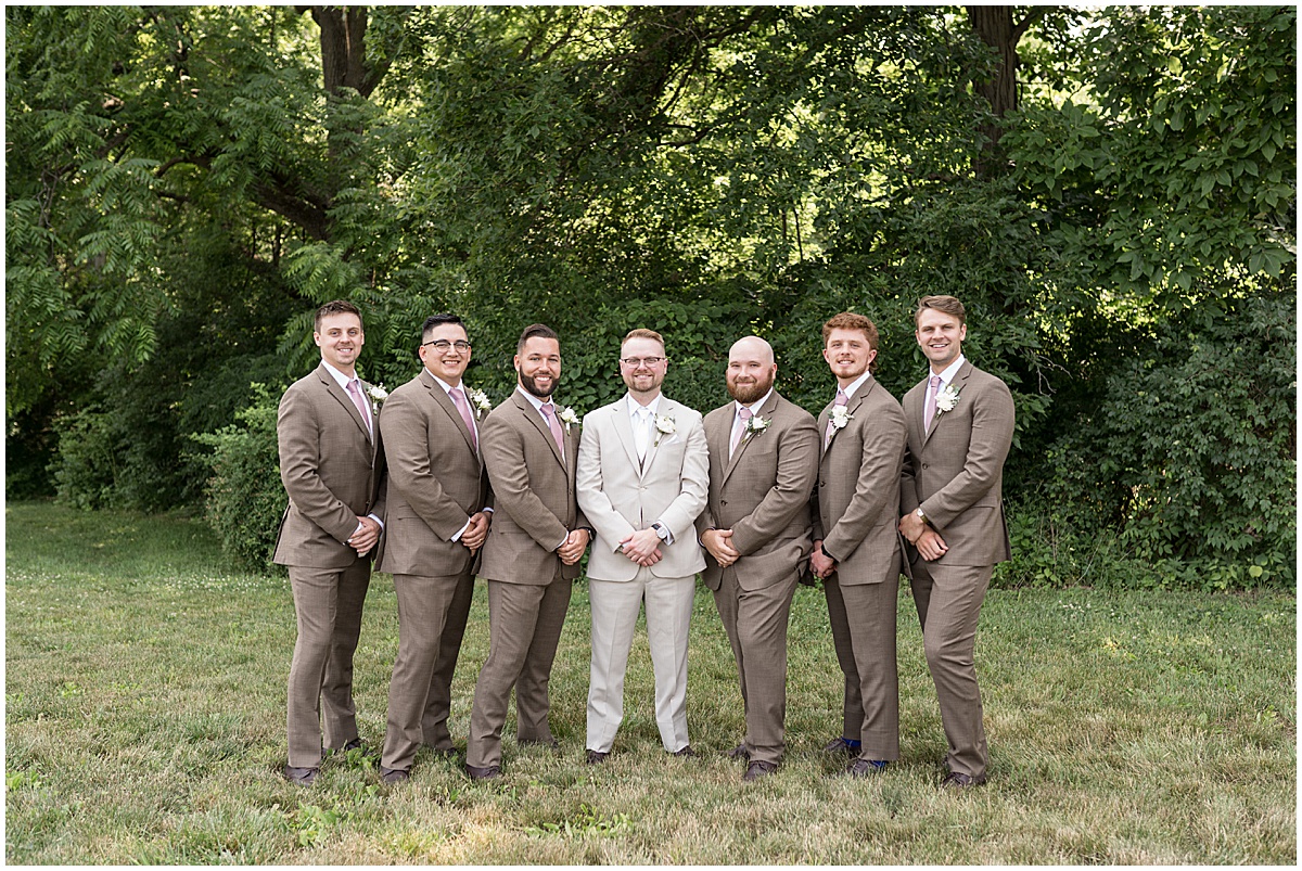 Outdoor portraits of groomsmen in tan at Stables Event Center wedding in Lafayette, Indiana