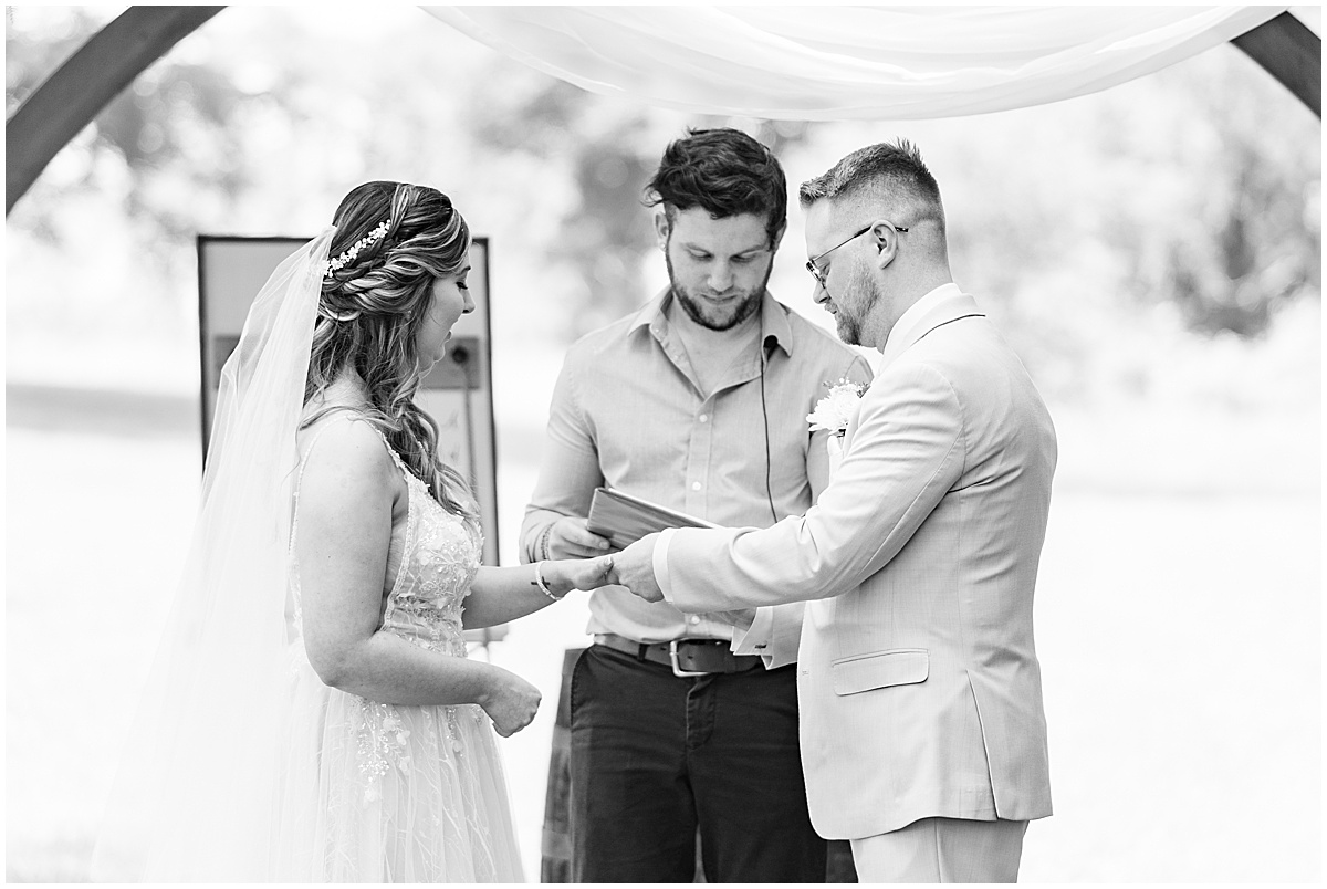 Groom gives ring to bride at Stables Event Center wedding in Lafayette, Indiana