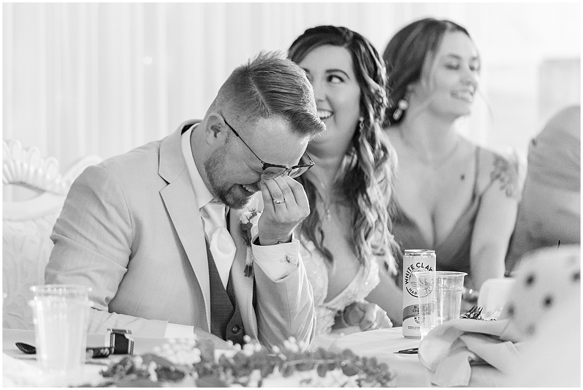 Groom laughs at speeches at Stables Event Center wedding in Lafayette, Indiana