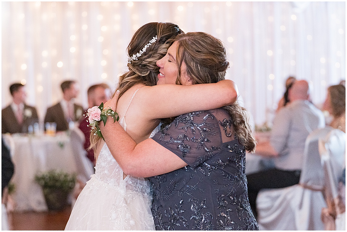 Bride hugs family after Stables Event Center wedding in Lafayette, Indiana