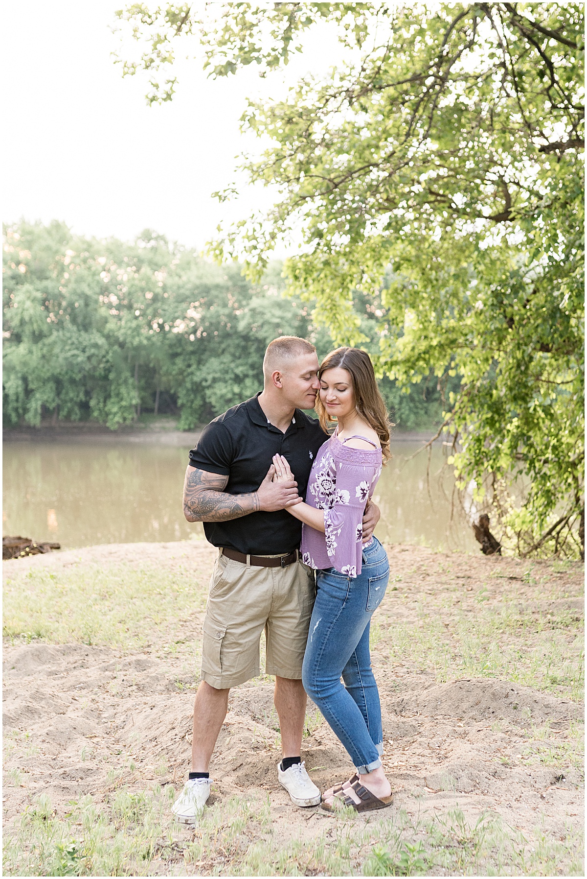 Couple by river at sunrise engagement photos in Lafayette, Indiana at Tapawingo Park