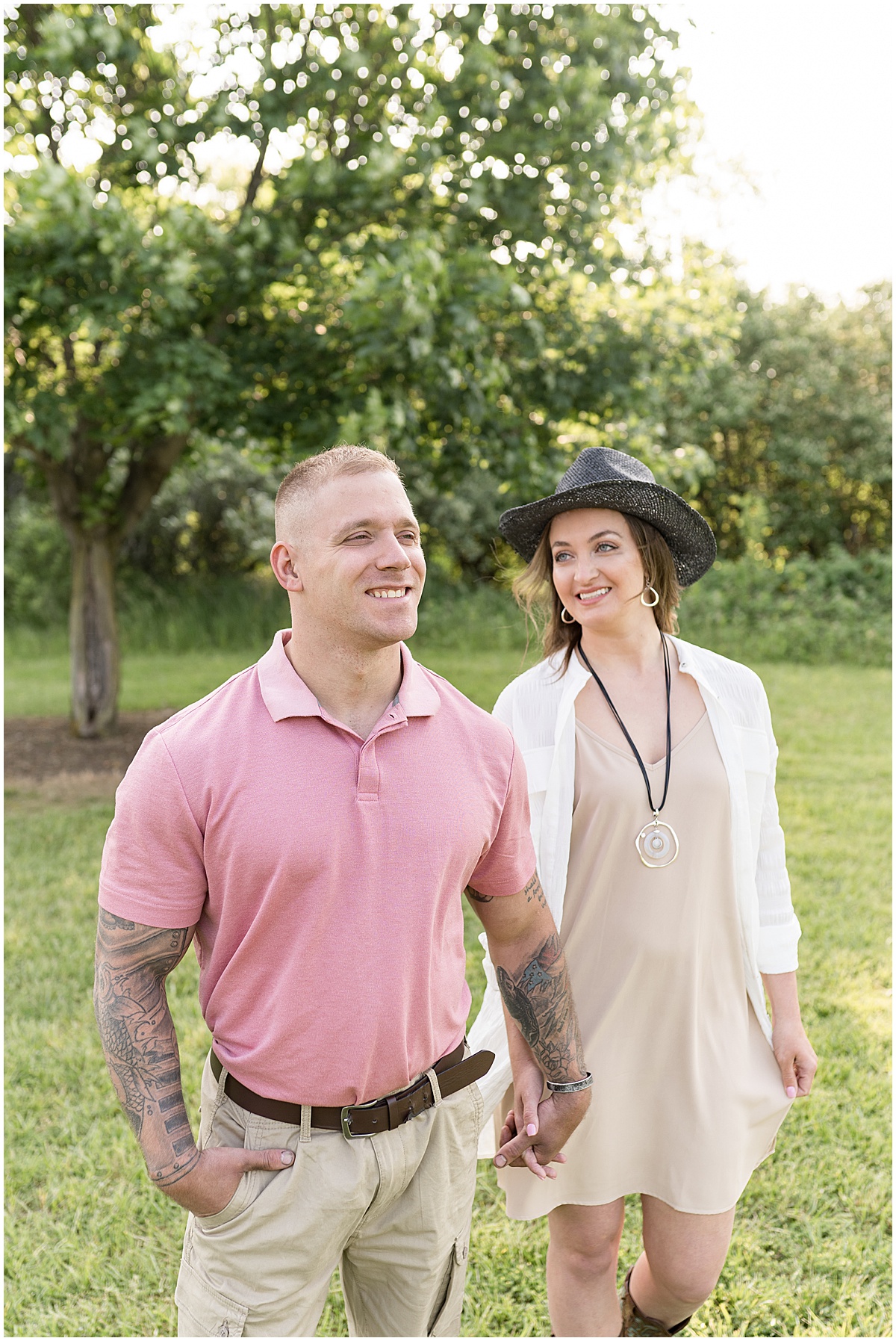 Couple walks through park at sunrise engagement photos in Lafayette, Indiana at Fairfield Lakes Park