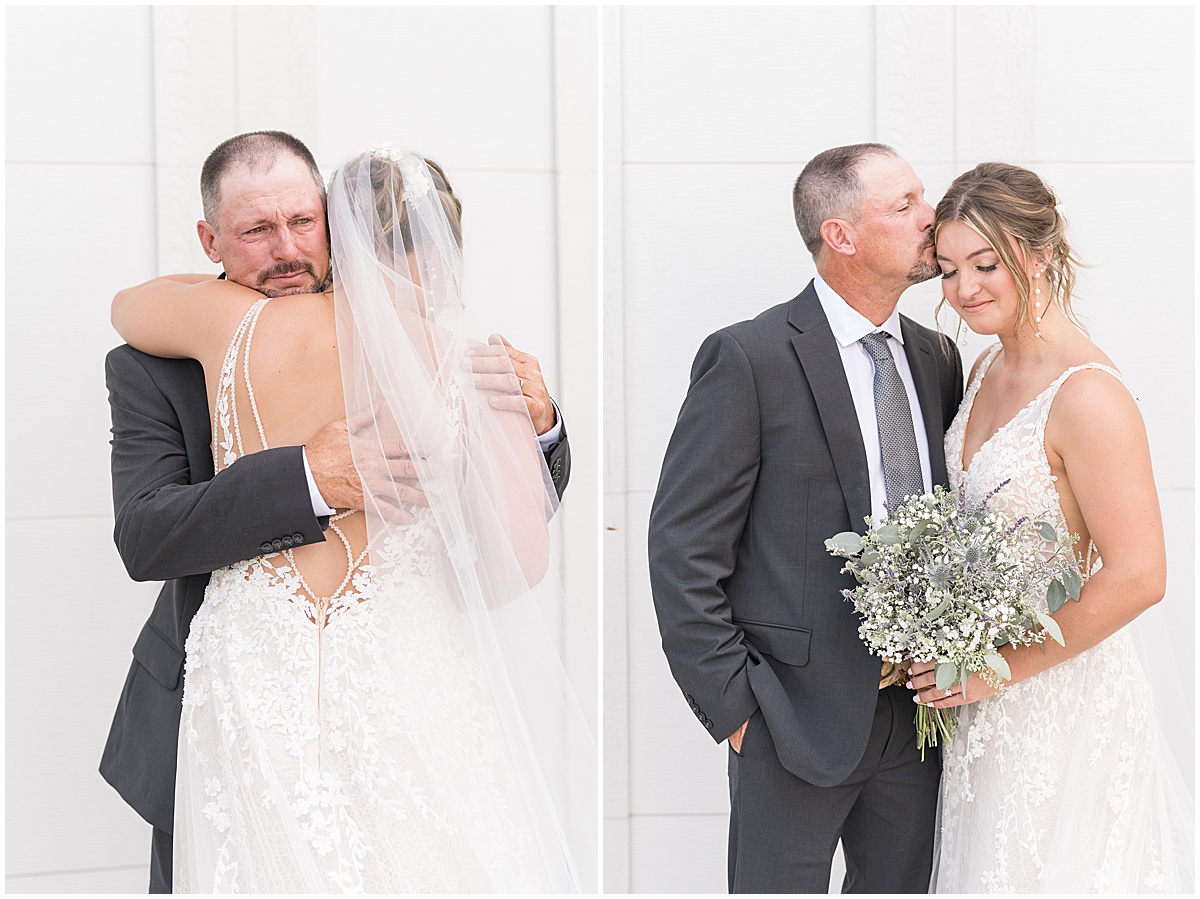 Father of the bride hugs and kisses bride before wedding