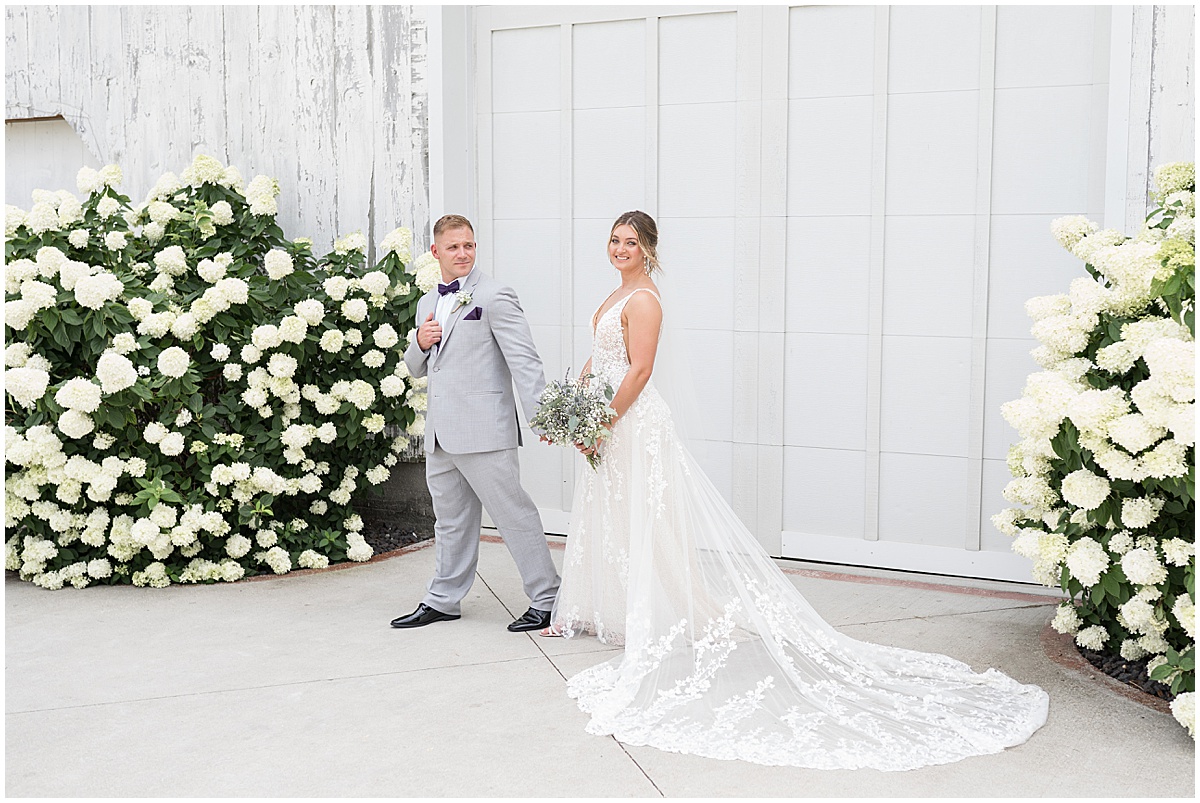 Groom leads bride outside of White Willow Creek Barn wedding in Frankfort, Indiana