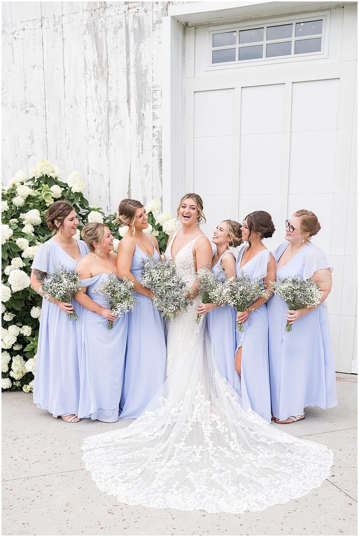 Bride with bridesmaids in lavender at White Willow Creek Barn wedding in Frankfort, Indiana